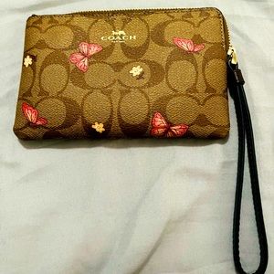 Coach wristlet with butterflies and flowers.